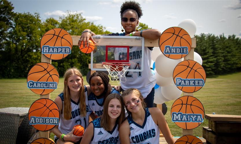 Students celebrate while on a homecoming parade float